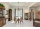 Sun-filled dining room showcases a glass table, light fixture, with adjacent vintage cabinetry at 7659 S 164Th Ln, Goodyear, AZ 85338