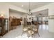 Bright dining room featuring a glass table, natural lighting, and lovely, decorative furnishings at 7659 S 164Th Ln, Goodyear, AZ 85338