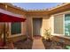 Inviting front entrance with a charming courtyard featuring desert landscaping and outdoor seating at 7659 S 164Th Ln, Goodyear, AZ 85338
