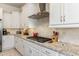 Modern kitchen featuring stainless steel appliances, granite countertops, and white cabinets at 7659 S 164Th Ln, Goodyear, AZ 85338