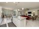 Open kitchen with granite island flows into the living area with tile flooring and stainless steel appliances at 7659 S 164Th Ln, Goodyear, AZ 85338