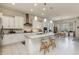 Bright kitchen with island, white cabinets, granite counters and modern stainless steel appliances at 7659 S 164Th Ln, Goodyear, AZ 85338