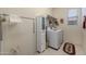 Well-lit laundry room with a new washer and dryer, cabinet, and hanging rack at 7659 S 164Th Ln, Goodyear, AZ 85338