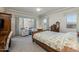 Cozy main bedroom with neutral tones, floral comforter, and picturesque outdoor views at 7659 S 164Th Ln, Goodyear, AZ 85338