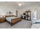 Spacious main bedroom offers a large bed, ceiling fan, and an adjacent outdoor patio at 7659 S 164Th Ln, Goodyear, AZ 85338