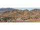 Mountain view with desert landscape and community parking with neighborhood at 7659 S 164Th Ln, Goodyear, AZ 85338