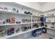 Walk-in pantry with ample shelving for organized storage of food and household items at 7659 S 164Th Ln, Goodyear, AZ 85338