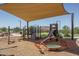 Shaded community playground with swings, slides, and climbing structures at 7659 S 164Th Ln, Goodyear, AZ 85338