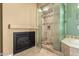 Bathroom featuring a glass shower, fireplace, and beautiful vanity at 8149 N 13Th Pl, Phoenix, AZ 85020