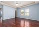 Light blue bedroom featuring hardwood floors, white trim, ceiling fan, and plantation shutters at 8149 N 13Th Pl, Phoenix, AZ 85020