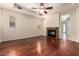 Bedroom featuring beautiful hardwood floors, ceiling fan, and a cozy fireplace at 8149 N 13Th Pl, Phoenix, AZ 85020