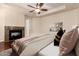 Comfortable bedroom featuring a fireplace, ceiling fan, and access to the rest of the home at 8149 N 13Th Pl, Phoenix, AZ 85020