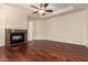 Bedroom featuring beautiful hardwood floors, ceiling fan, and a cozy fireplace at 8149 N 13Th Pl, Phoenix, AZ 85020