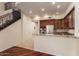 Open kitchen featuring wood cabinets, stainless steel appliances, and granite countertops next to the ornate staircase at 8149 N 13Th Pl, Phoenix, AZ 85020