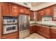 This kitchen features stainless steel appliances, double oven, cooktop, granite counters and wooden cabinets at 8149 N 13Th Pl, Phoenix, AZ 85020