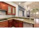 Bright kitchen featuring stainless steel appliances, light granite countertops, and wooden cabinetry at 8149 N 13Th Pl, Phoenix, AZ 85020