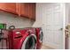 Laundry room with red washer and dryer and tile floors at 8149 N 13Th Pl, Phoenix, AZ 85020