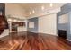 Open-concept living room showcasing hardwood floors, a fireplace, and a view of the adjacent kitchen at 8149 N 13Th Pl, Phoenix, AZ 85020