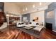 Open-concept living room showcasing hardwood floors, a fireplace, and a view of the adjacent kitchen at 8149 N 13Th Pl, Phoenix, AZ 85020