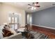 Staged living room featuring hardwood floors, ceiling fan, furniture, and open floor plan at 8149 N 13Th Pl, Phoenix, AZ 85020