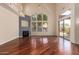 Bright living room with high ceilings, large windows, hardwood floors, and a cozy fireplace at 8149 N 13Th Pl, Phoenix, AZ 85020
