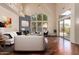 Bright living room with high ceilings, large windows, hardwood floors, and a cozy fireplace at 8149 N 13Th Pl, Phoenix, AZ 85020