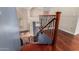 View of staircase with wooden treads, wrought iron railings, and hardwood floors at 8149 N 13Th Pl, Phoenix, AZ 85020