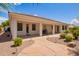 Charming backyard featuring a covered patio, walkway, and beautiful landscaping for outdoor enjoyment at 815 W Juniper Ln, Litchfield Park, AZ 85340