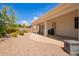 Attractive backyard with a covered patio, manicured landscaping, and a stone path, perfect for outdoor living at 815 W Juniper Ln, Litchfield Park, AZ 85340