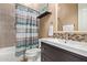 Contemporary bathroom features a sleek vanity, patterned shower curtain, and a well-lit mirror for a modern feel at 815 W Juniper Ln, Litchfield Park, AZ 85340