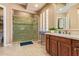 Bathroom featuring a spacious walk-in shower with glass doors, double sink vanity, and tile floors at 815 W Juniper Ln, Litchfield Park, AZ 85340