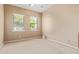The bedroom has neutral walls, carpet floors, and two large windows providing a bright atmosphere at 815 W Juniper Ln, Litchfield Park, AZ 85340