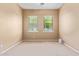 The bedroom has neutral walls, carpet floors, and two large windows providing a bright atmosphere at 815 W Juniper Ln, Litchfield Park, AZ 85340