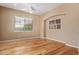 Bright and airy bedroom showcasing hardwood floors, a large window, and a classic archway, offering comfort and style at 815 W Juniper Ln, Litchfield Park, AZ 85340