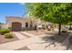 Lovely single-story home with a private garage, drought-tolerant landscaping, and inviting curb appeal on a sunny day at 815 W Juniper Ln, Litchfield Park, AZ 85340