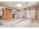 Spacious three-car garage with storage cabinets and multiple garage doors, offering ample space for vehicles and storage at 815 W Juniper Ln, Litchfield Park, AZ 85340