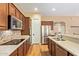 Beautiful kitchen with granite countertops, stainless appliances, and counter seating, complete with hardwood floors at 815 W Juniper Ln, Litchfield Park, AZ 85340