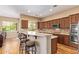 Bright and airy kitchen featuring custom cabinets, island, and stainless steel appliances, with hardwood floors at 815 W Juniper Ln, Litchfield Park, AZ 85340