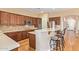 Spacious kitchen boasts granite countertops, stainless appliances, ample cabinetry, and a breakfast bar with seating at 815 W Juniper Ln, Litchfield Park, AZ 85340