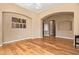 Spacious living area featuring hardwood floors, arched doorways, and neutral paint, creating a welcoming atmosphere at 815 W Juniper Ln, Litchfield Park, AZ 85340
