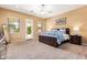 This main bedroom has neutral walls, carpet floors, large windows and an exit to the backyard at 815 W Juniper Ln, Litchfield Park, AZ 85340