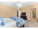 This main bedroom has neutral walls, carpet floors, a ceiling fan, and an exit to the bathroom at 815 W Juniper Ln, Litchfield Park, AZ 85340