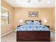 This main bedroom features neutral walls, carpet floors, a ceiling fan and a large bed at 815 W Juniper Ln, Litchfield Park, AZ 85340