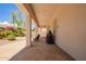 Comfortable covered patio with chairs and a grill, offering a relaxing outdoor living space at 815 W Juniper Ln, Litchfield Park, AZ 85340