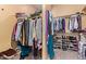 Spacious walk-in closet with ample storage including shelving and hanging rods for organization at 815 W Juniper Ln, Litchfield Park, AZ 85340