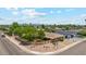 Aerial view of a house showcasing the surrounding neighborhood and mature trees at 8202 E Coolidge St, Scottsdale, AZ 85251