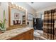 Bathroom features a granite-topped vanity, wood cabinets, black tile shower, and updated lighting at 8202 E Coolidge St, Scottsdale, AZ 85251