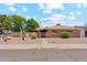 Charming single-story home featuring a brick facade and well-manicured desert landscaping at 8202 E Coolidge St, Scottsdale, AZ 85251