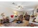 Cozy living room featuring neutral-toned furnishings, a ceiling fan, and a decorative rug at 8202 E Coolidge St, Scottsdale, AZ 85251