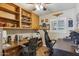 Home office featuring built-in shelving, wooden desks, tile floors, and ample natural light from the window at 8202 E Coolidge St, Scottsdale, AZ 85251